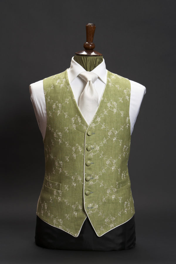 Green linen waistcoat with ivory embroidery and ivory piping